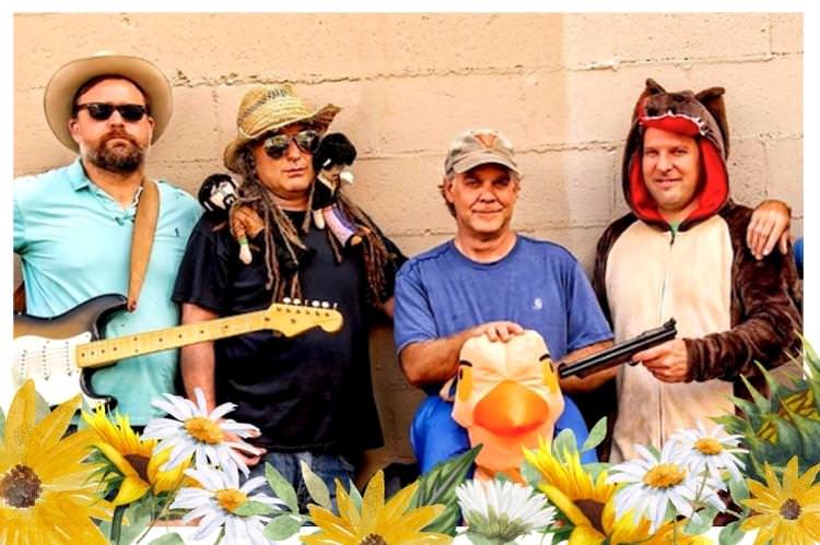 4 men in t-shirts, hats, and one dressed as a monkey. Two holding guitars